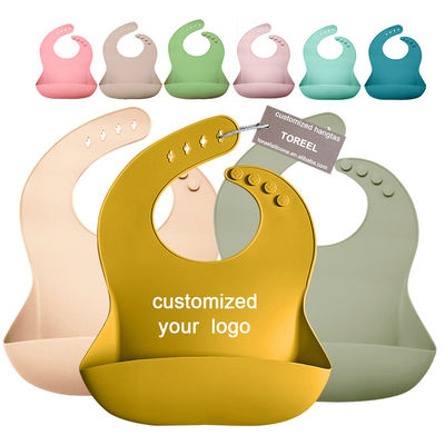 OEMの食糧キャッチャーが付いている注文の調節可能な長さのシリコーンの赤ん坊の胸当て